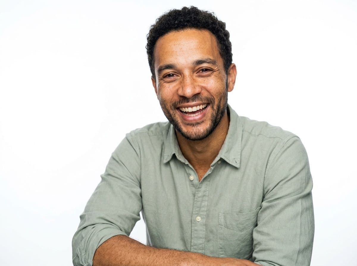 Bright commercial AI actor headshot with a natural laugh
