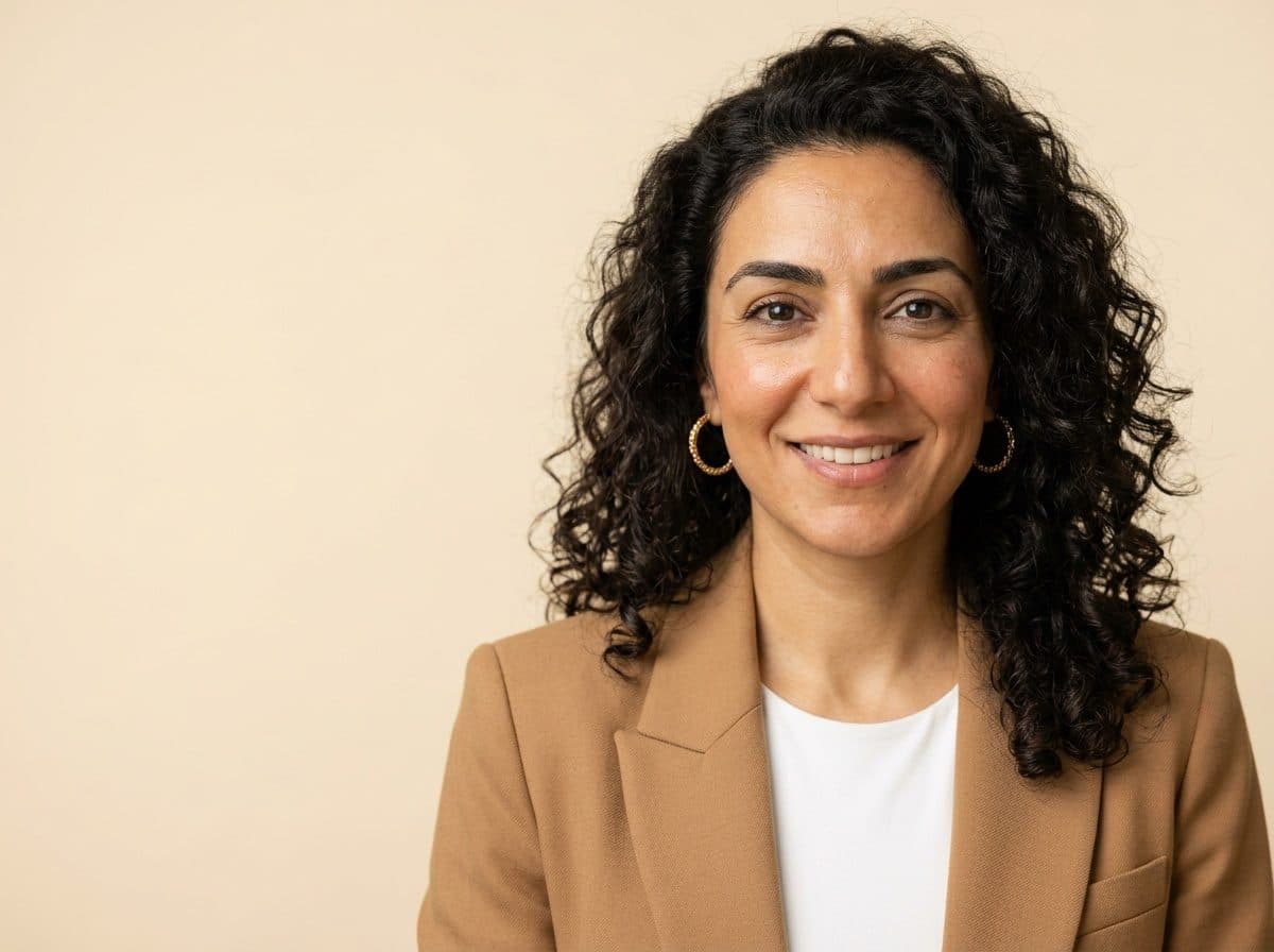 AI LinkedIn headshot of a professional woman on a warm studio backdrop